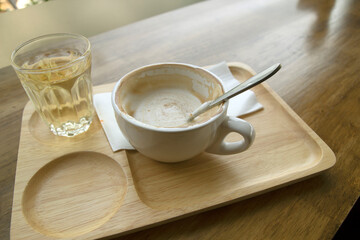 Hot coffee in a cup and tea mug on a wooden table