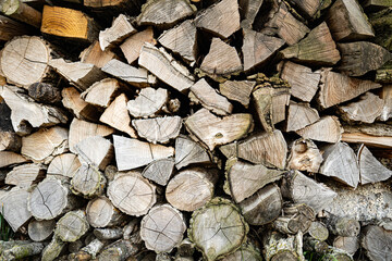 Stacked logs of wood, wooden background, firewood, brown and gray. Wallpaper Texture, graphic resources