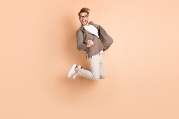 Full body profile side photo of charming crazy celebrate winner jump up air wear glasses isolated...
