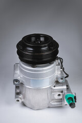 New freon air conditioner compressor on a gray background. Copy space presentation