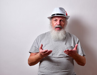 Retired American male with a long white beard holding both hands out