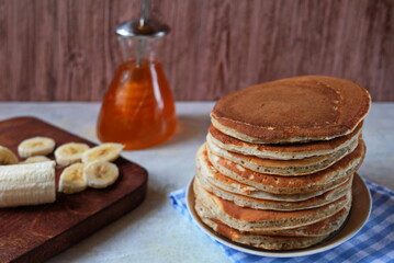 A stack of banana pancakes on a blue plate. Traditional American Breakfast. The concept of home made healthy food.