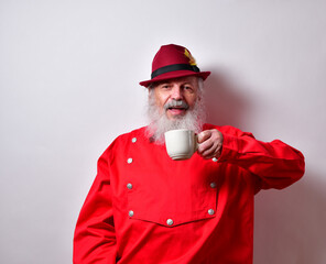Retired American male with red western bib shirt drinking a cup of coffee