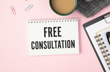 Free consultation text write on notebook on pink background.