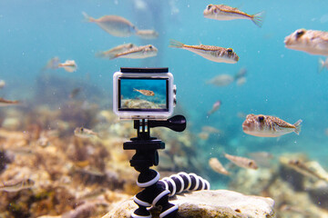 Using action-camera in waterproof box to make photos and video underwater
