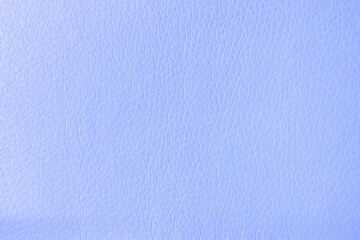 The surface of artificial blue leather used for furniture upholstery. Uniform light texture.