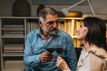 middle age romantic couple celebrating anniversary at home