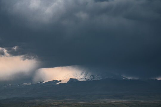 View of the mountain in the storm clouds. The elements in the valley