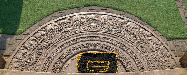 Stone carved moonstone pattern in Kingdom of Anuradhapura era at Jaya Sri Maha Bodhi entrance.