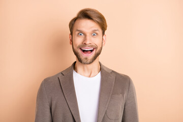 Photo of funny impressed young gentleman dressed blazer smiling big eyes open mouth isolated beige color background