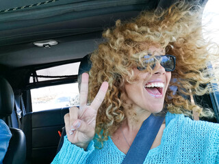 Travel with car and happiness - joyful beautiful adult woman enjoy travel and have fun looking...