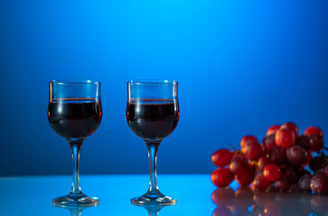 Two glasses of wine on a beautiful blue background. holiday mood