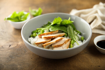 Healthy rice bowl with chicken and spinach