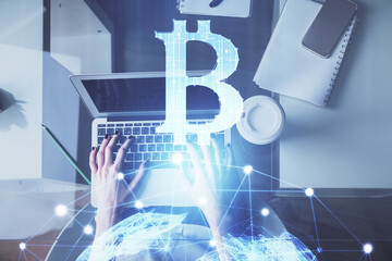 Double exposure of woman hands working on computer and blockchain theme hologram drawing. Top View. bitcoin cryptocurrency concept.