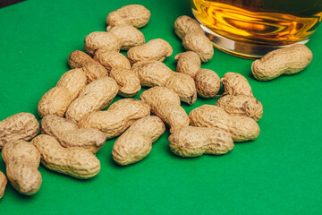 peanuts in shells snack Green background snack for alcohol