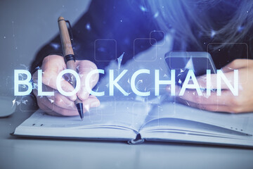Double exposure of woman hands typing on computer and crypto market theme hologram drawing....