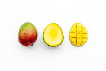 Mango fruit and mango cubes top view. Tropical fruits background