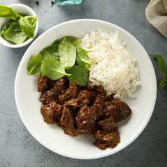 Homemade beef ragout with spinach and rice