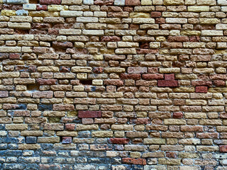 Horizontal part of a Venetian old red brick wall, background,