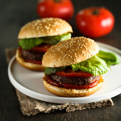 Homemade burgers with tomato and basil