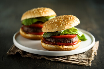 Homemade burgers with tomato and basil