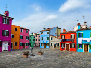Colorful houses on a small traditional square at Burano island, Venice, Italy
