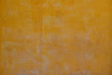 Rough yellow concrete wall background, dirty yellow background