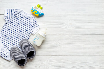 Baby accessories with bodysuit and shoes. Flat lay