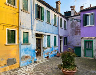 Multicolored houses on a little square at Burano island, Venice, Italy