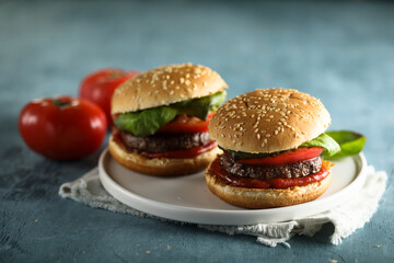 Homemade burgers with tomato and basil