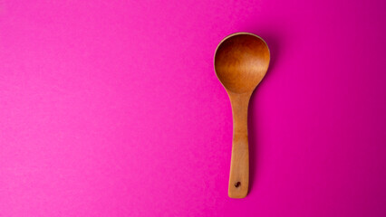 wooden spoon for food on a colored background. old vintage spoon