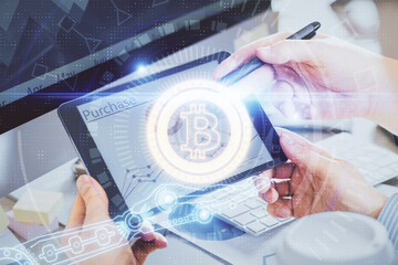 Double exposure of man's hands holding and using a phone and crypto currency blockchain theme...