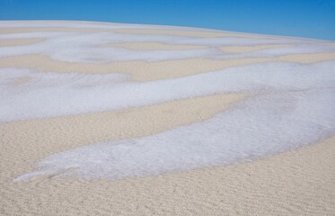Fototapeta na wymiar Snow on the ground in White Sands National Park in New Mexico USA