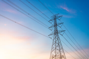 high-voltage power lines, high voltage electric transmission tower for producing electricity at high voltage electricity poles at the sunset.