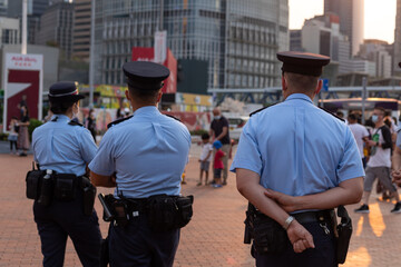 well-equipped Police patrolling in Central, Hong Kong, China in evening. - obrazy, fototapety, plakaty