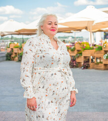 Woman of plus size, American or European appearance walks at the city enjoying life. A young lady...