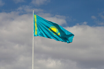 the flag of Kazakhstan, the national flag of the Republic of Qazaqstan, the flag of Kazakhstan flies in the wind