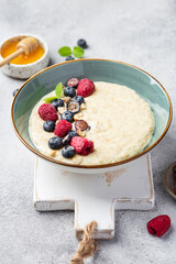 oatmeal with berries in bowl on white background