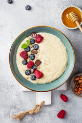 oatmeal with berries in bowl on white background