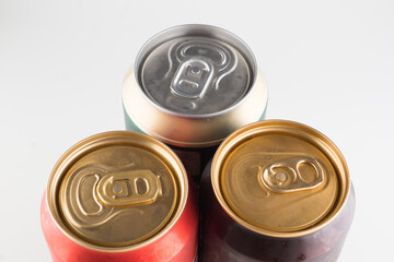 three metal cold cans with beer
