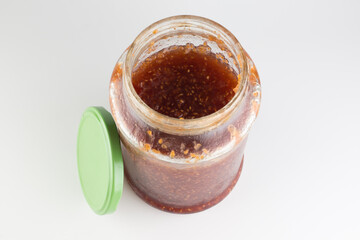 glass jar with raspberry jam isolated