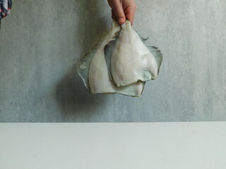 two fresh flounders, large and small, before cooking.