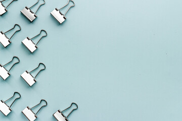 Paper binder clips. Stationery and office supplies background.