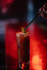 Bloody Maria cocktail decorated with salt, slice of lime and olives garnish.