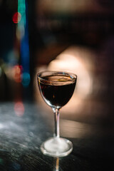 Manhattan cocktail decorated with lemon zest.