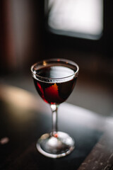 Manhattan cocktail decorated with lemon zest.