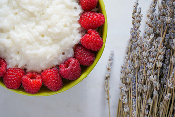 Rice milk porridge with raspberries and blueberries for breakfast. Healthy breakfast, top view.   