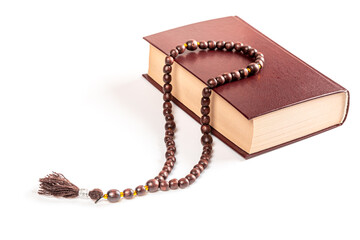 Muslim holiday of the holy month of Ramadan Kareem. Beautiful background with religious book quran and prayer beads on white