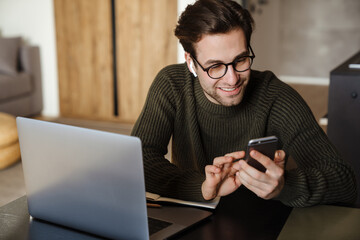 Mid aged man working on laptop computer from home