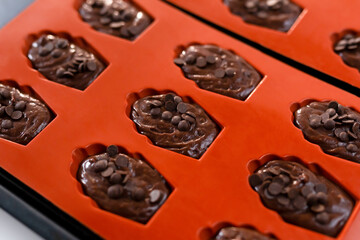 Madeleine with chocolate in an orange baking dish